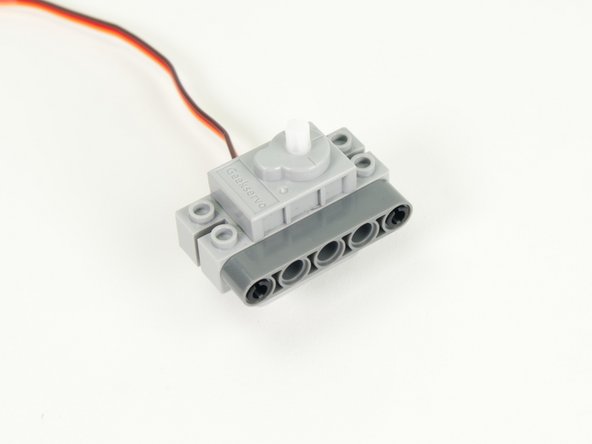 Attach a gray 5 beam to the pins on the servo.