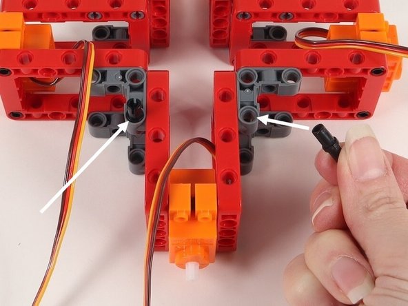Add two black pins onto the 90° connectors on one side of the build. It does not matter at this point which side these go on since the build is symmetrical.