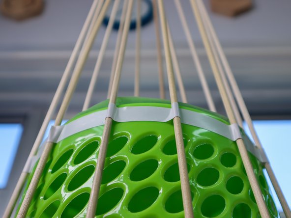 I used a long piece of electric tape and positioned each dowel as I spun the basket around, but you could also use individual pieces of tape.