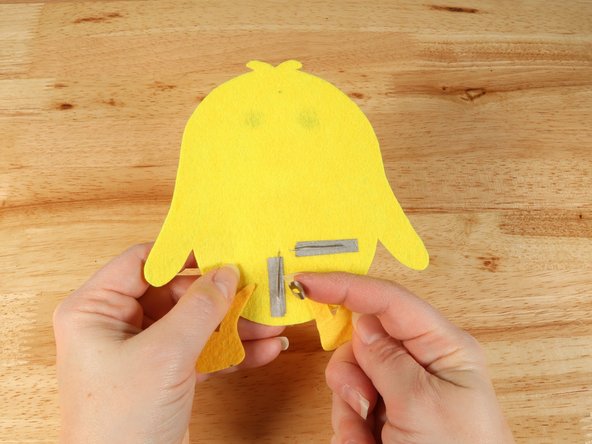 Make a loop of tape (sticky side out) using a short piece of Maker Tape, and stick it atop the end of the path coming from the short (Negative) LED leg.