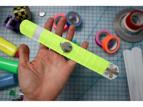 To embellish the band, wrap colorful tape around it, but don't cover the Xs!