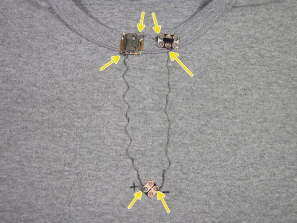 Turn the shirt inside-out. Place clear nail polish or super glue over the knots where shown, to keep the circuit working for a long time!