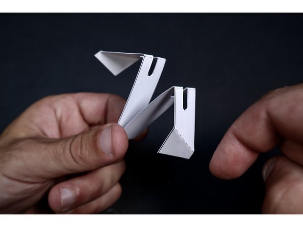 Now fold at the remaining two dotted lines in the same direction. Thread the narrow shaft of the whirlybird body through the middle slot of the Rotor Blade to the lowest point possible.