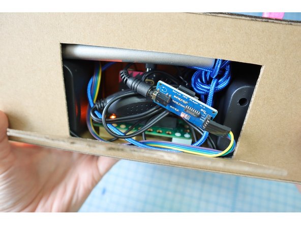 Stuff everything inside the box. If your speakers have a volume adjustment, set it to full volume before closing the door.