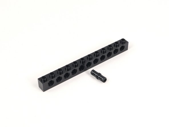 Add a black pin to the center hole of the 1x12 brick with holes.