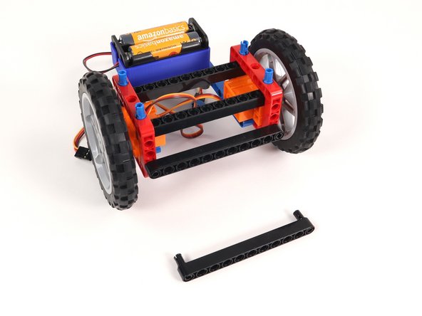 Remove the two long black beams on the front of the Rover as well as the black pins holding them in place.