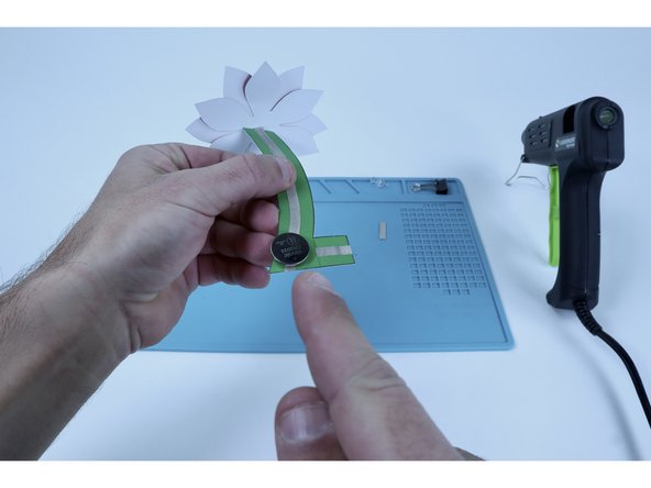 Stick battery atop this tape loop so that the positive (+) side is facing UP.