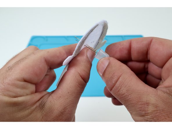 Thread  the two legs of one LED  through one of those pairs of holes. The orientation of the long and short LED legs doesn't matter for the first LED.