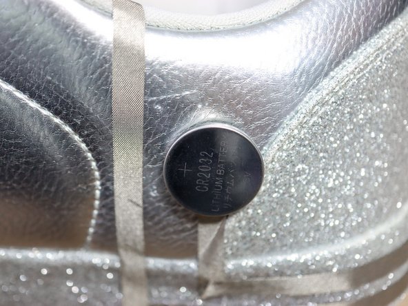 Then, start a 1-foot piece of Maker Tape towards the back of the shoe as shown, and place the battery on top of it.