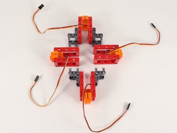 Connect the servos with 90° connectors to the frame without connector, creating a 4 sided shape with all servo shafts pointing outward.