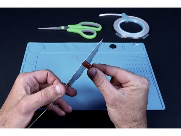 Thread the LED legs through those two holes from the front as shown. Take care to insert the long LED leg into the right hole (when viewed from the font) and the shorter LED leg into the left hole.