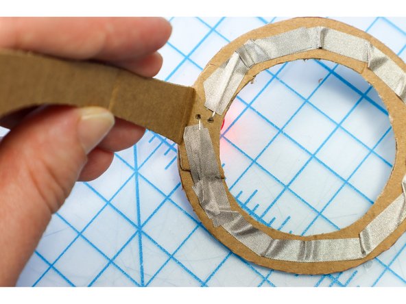 With the circuit connected, it should light up! Check that both LEDs are illuminated, and if not, check the circuit connections on each side.