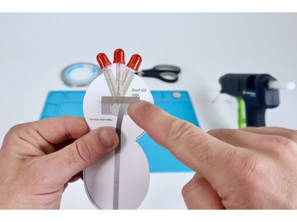 Peel and stick these three pieces where shown so that each piece overlaps the next, forming a connected "pad".