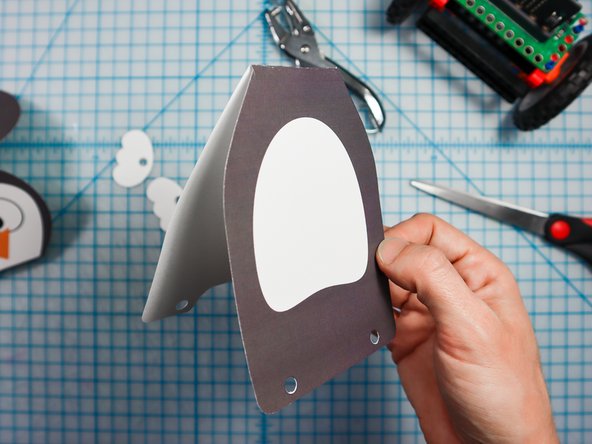 Fold along the dotted lines as shown.