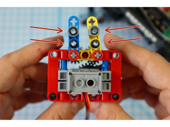 Add 4 black pins to the holes in the half beams as shown.
