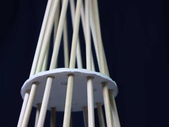 Push the circle down until the dowels form a point at the top.