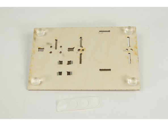 Peel the feet off the strip they are attached to so you can stick them to the base.