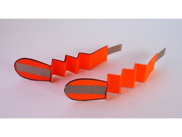 Fold the leg in a zig-zag pattern using the creases you made in Step 10.