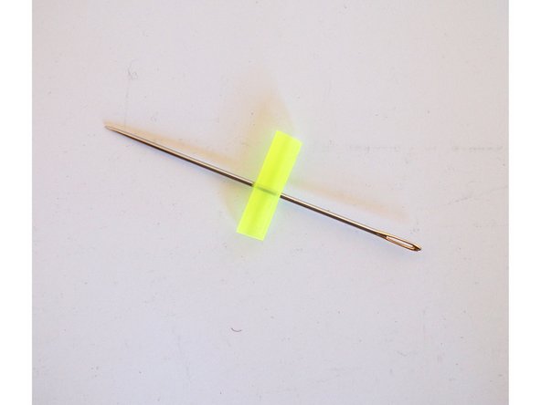 Use the needle to poke a hole through the straw at about halfway between the top and bottom