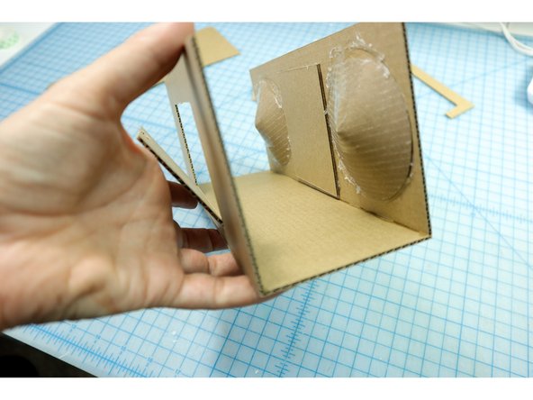 Glue the bottom and back pieces in place. It can be helpful to use a box or other 90 degree angled object to align the angle.