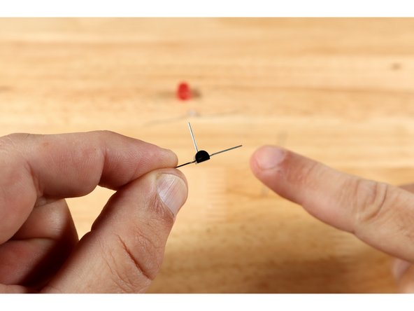 The two legs of both the LED and the LDR should be folded outward in opposite directions, allowing them to lay flat in the places pictured on the template. The legs of the LDR are both the same length and it can be placed on the diagram in any orientation. The LED legs, however, are different lengths and the orientation needs to match the diagram.