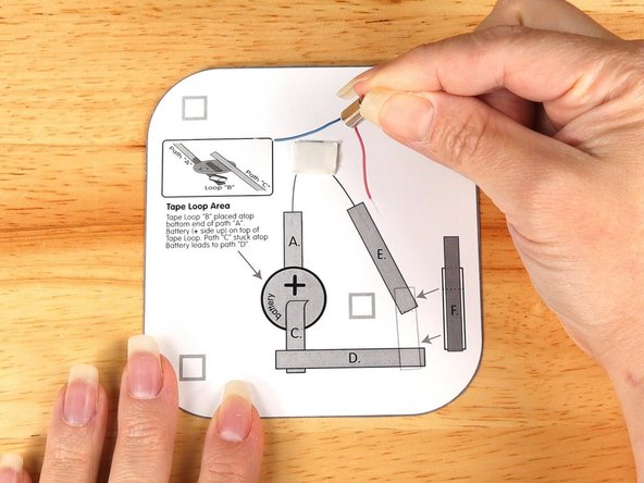 Stick the motor to the double sided tape making sure the back of the motor (with the wires) is stuck down to the tape and the part that spins faces upwards so it can move freely.