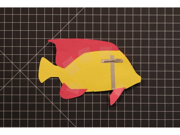You can use glue, but tape can be a bit quicker and easier, and it will be hidden since it’s on the backside of our fish.