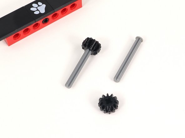 Add a small black gear to an axle with end stop and push it all the way down to the end stop. You will need two of these.