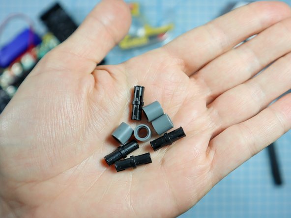 Connect each LEGO pin to a LEGO round beam as shown.