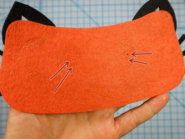 Use a push pin to make two holes for the LED's legs. When the push pin is inside the felt, rotate it around a bit to make the hole larger and easier to see.