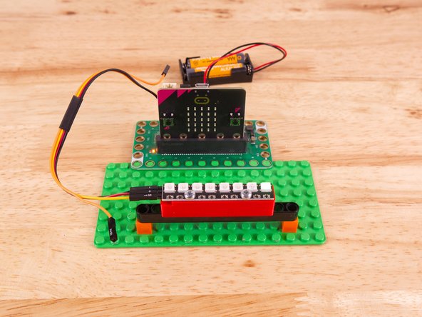 To mount the NeoPixel Stick in place we used our NeoPixel Beam Holder with a long Technic Beam and two 1x1 LEGO bricks.