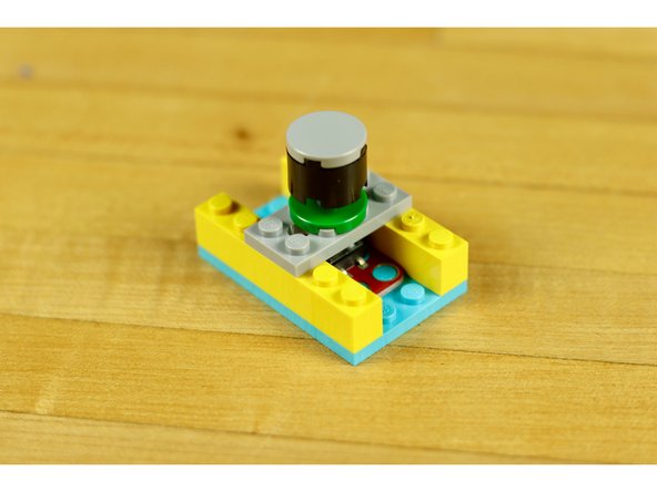 Just place your plate over the top of the switch so the axle makes contact with the button.