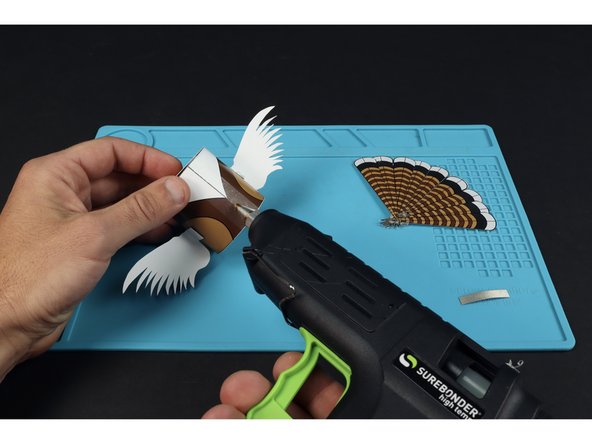 Use hot glue to add any included embellishments.