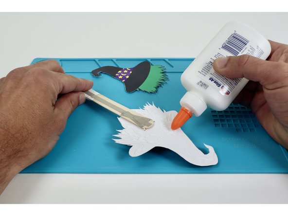 Use some glue to stick the back panel in place as shown to cover the circuitry.