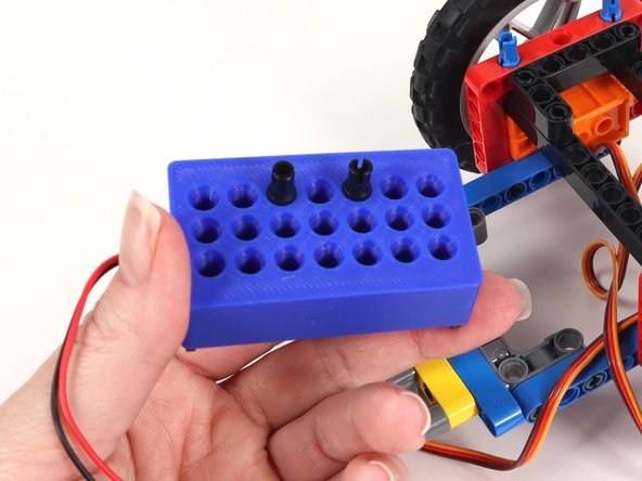 Adjust the location of the two black pins on the bottom of the battery pack. They should be moved to the top row with an empty hole in between them.