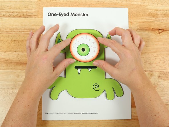 Add another square of double-sided tape onto the shaft of the motor, and then stick the eye to it.