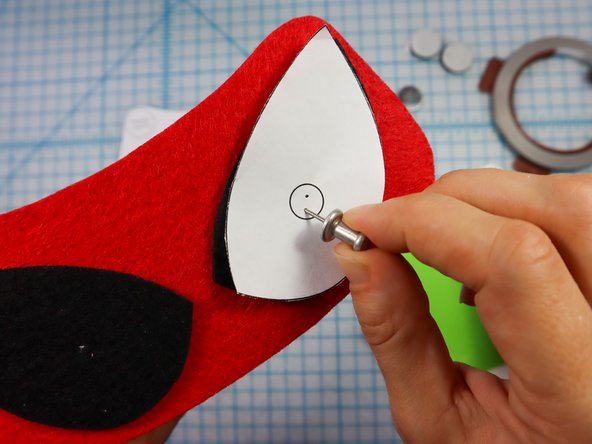 Use a push pin to make two holes for the LED's legs. When the push pin is inside the felt, rotate it around a bit to make the hole larger and easier to see.
