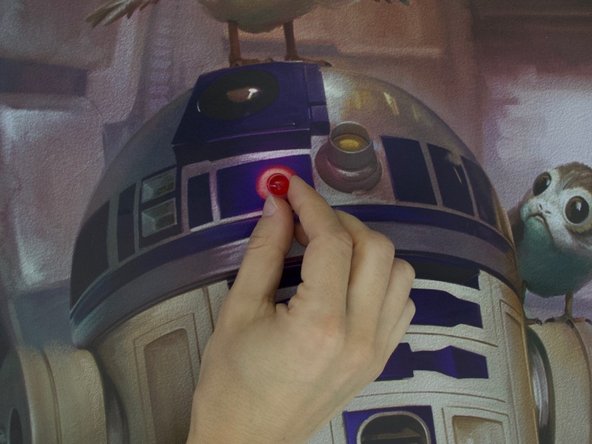 Tip: If you don't have a safety pin, make a horizontal slit in the poster with your craft knife and press both LED legs thought the slit.