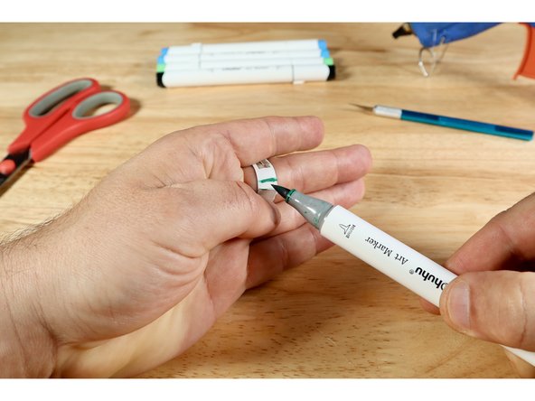 Bend and wrap the two parts of the ring band around a finger you wish to wear the ring on and mark where they overlap.