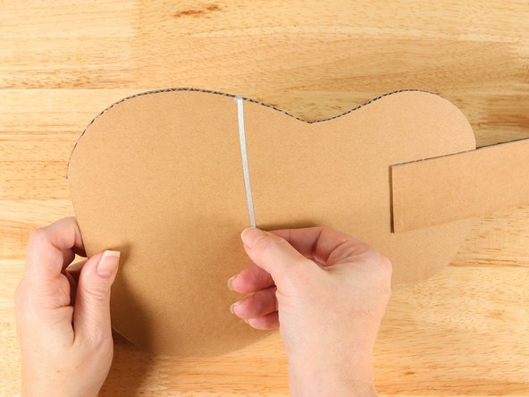 Wrap the tape path onto the back side of the guitar. If your path isn't long enough, add more tape overlapping the pieces to connect them.