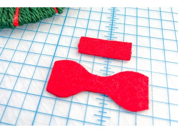Then, I used the template to make a felt bow, hot gluing it together and then gluing it to the wreath.