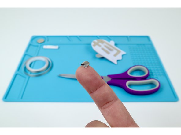 Use that piece of Maker Tape to create a sticky-side-out tape loop.