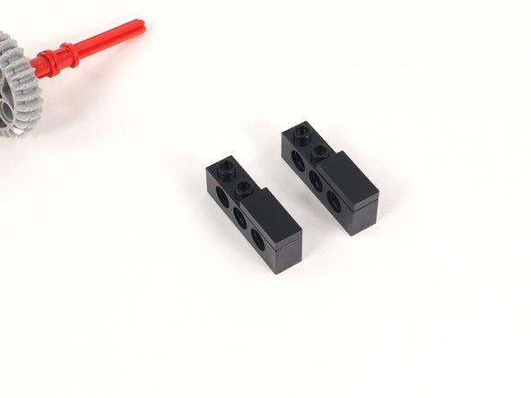 Add a 1x2 tile to the last two studs of a 1x4 brick with holes. You will need two of these.