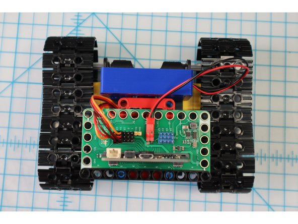 To add the paper robot template, we'll need to adjust the angle of the battery pack by switching out the pins.