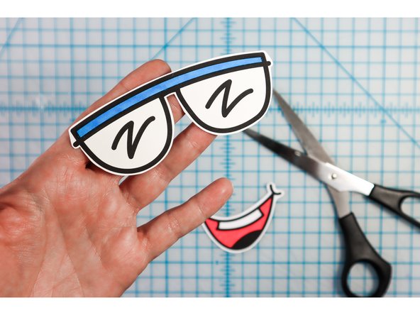 Cut them out, then glue or tape them to the body.