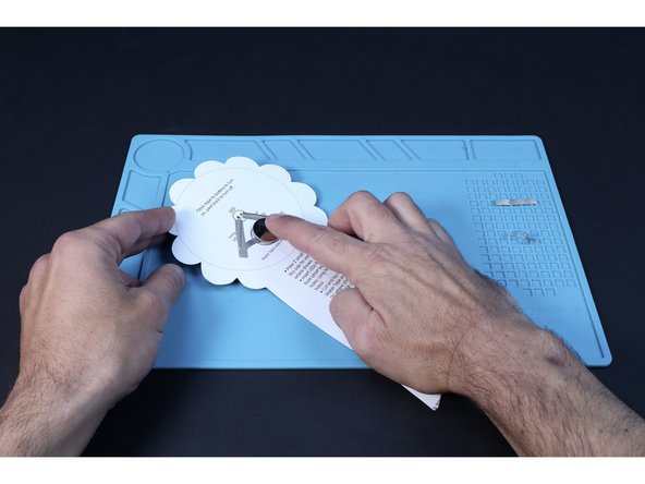 Stick the battery atop the tape loop with the positive (+) side facing UP.