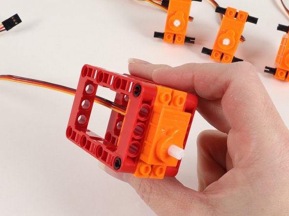 Continue adding red frames until all 4 servos have two red frames on the black pins.