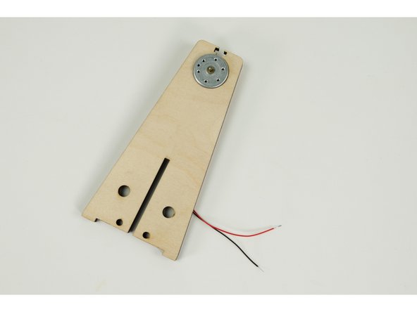 The motor should press fit into the round hole at the top of the windmill frame. (Press the front of the motor in place through the hole.)