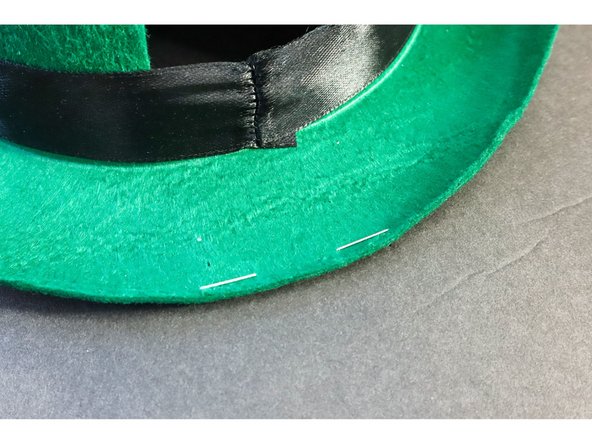 Staple the hat's brim to the foam core to make a hinge as shown. (If you're using a cardboard box, cut off all but one of the flaps and staple the remaining flap to the foam core.)