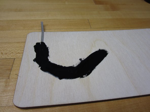 Take a long piece of tape and apply it to your work area. Fold it over and have it connect to the back side if your board.